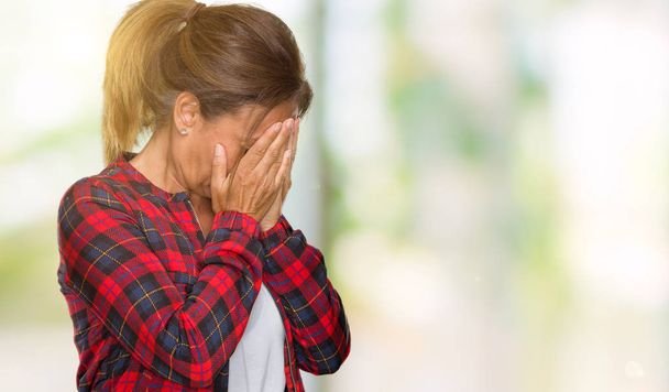 Middle age adult woman wearing casual jacket over isolated background with sad expression covering face with hands while crying. Depression concept. - Photo, Image