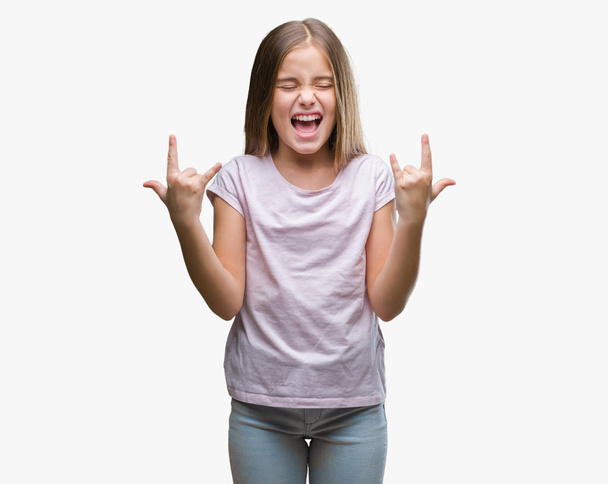 Young beautiful girl over isolated background shouting with crazy expression doing rock symbol with hands up. Music star. Heavy concept. - Zdjęcie, obraz