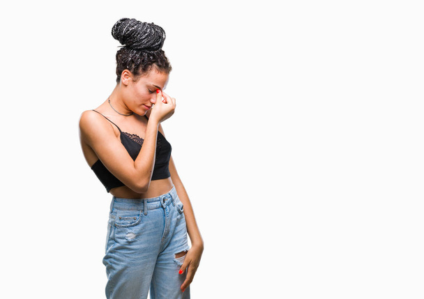 Young braided hair african american with pigmentation blemish birth mark over isolated background tired rubbing nose and eyes feeling fatigue and headache. Stress and frustration concept. - Foto, Imagen