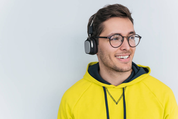 happy young male with headphones isolated on white background - Valokuva, kuva