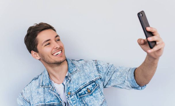 attractive caucasian male in stylish posing for selfie  - Photo, Image