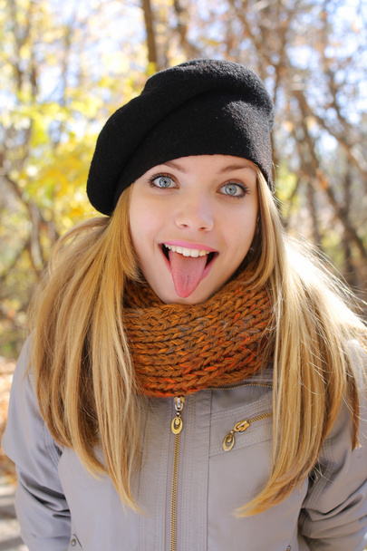 Funny blonde girl shows tongue - Foto, immagini