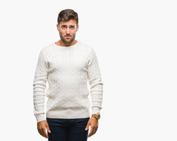 Young handsome man wearing winter sweater over isolated background depressed and worry for distress, crying angry and afraid. Sad expression. - Foto, afbeelding