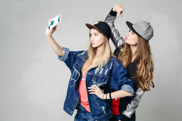 Two swag sisters taking self portrait on call phone. - Photo, Image