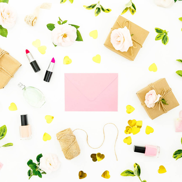 Composition with flowers, pink envelope, cosmetics and gifts boxes on white background. Flat lay, top view. Valentines day concept - Photo, Image