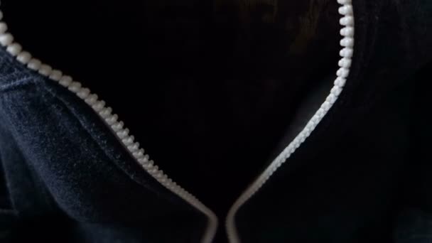Female hands zip up a hoodie in close-up. - Footage, Video