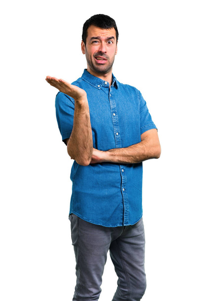 Handsome man with blue shirt unhappy and frustrated with something. Negative facial expression - Fotoğraf, Görsel