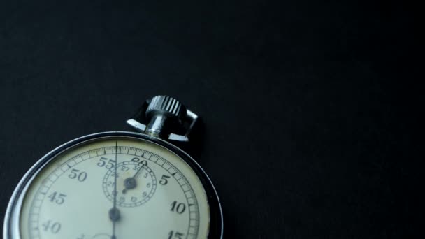 Analogue metal stopwatch on the black background - Footage, Video