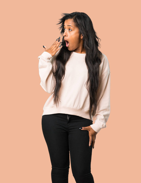 Young afro american woman yawning and covering wide open mouth with hand on isolated brown background - Photo, image