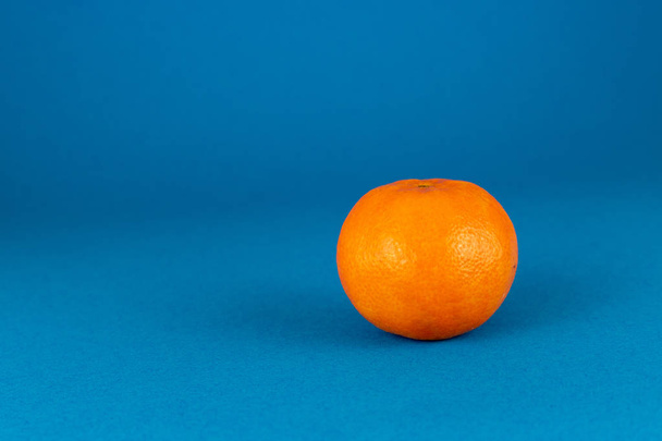 Fresh peeled mandarin orange isolated on blue background - Фото, изображение