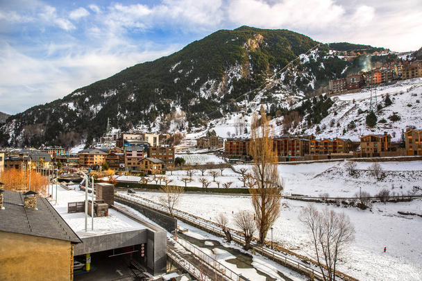 Hotels in the bottom of a mountain with snow during the winter of Andorra in Europe - Photo, Image