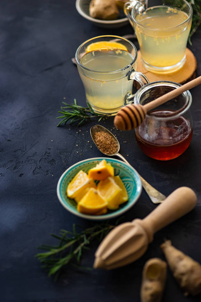 Detox drink with ginger and lemon on rustic background with copy space - Fotó, kép