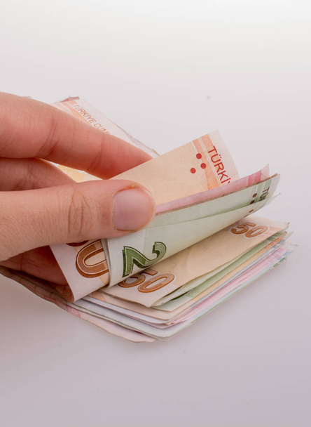 Billetes turksh lira de mano sobre fondo blanco
 - Foto, Imagen