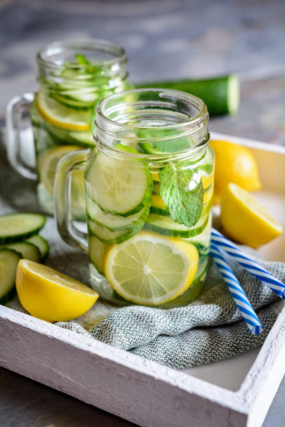 Healthy alkaline water with sliced cucumber, ginger, lemon and mint - Fotoğraf, Görsel