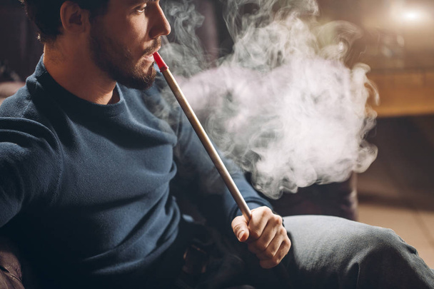 young handsome man is a great smoker - 写真・画像