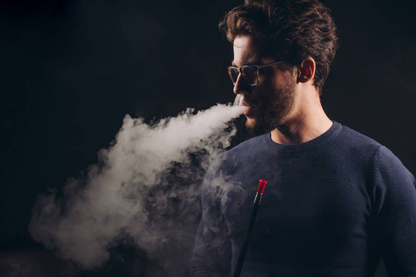 awesome man smoking flavored tobacco - 写真・画像