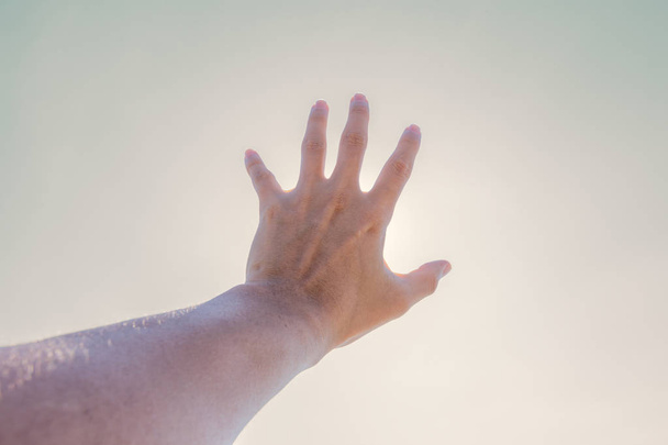 Hand of a man reaching to towards sky. Hand make symbol. - Valokuva, kuva