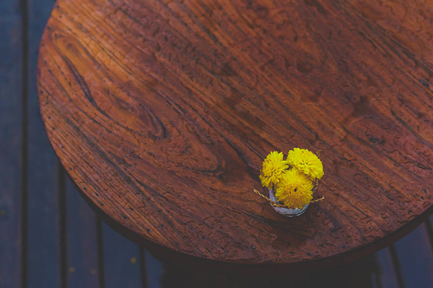 a little yellow flowers in vase on the table. - Fotó, kép