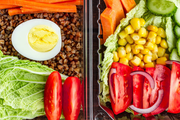 Dietary, healthy meal in a plastic container. Eat right concept. Snack at work, in the office at lunch time, during a break. Lunch box. Healthy food and nutrition concept  - Photo, Image