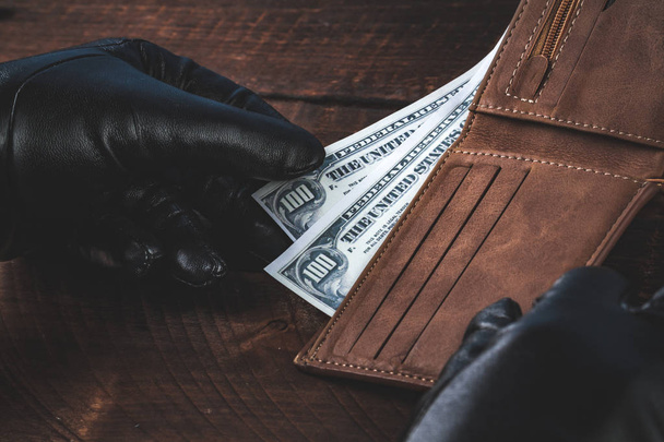 Stealing money from a wallet. Theft concept. - Foto, Bild