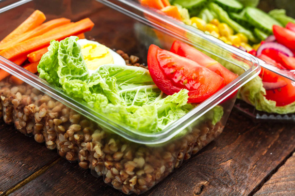 Dietary, healthy meal in a plastic container. Eat right concept. Snack at work, in the office at lunch time, during a break. Lunch box. Healthy food and nutrition concept  - Foto, Imagem