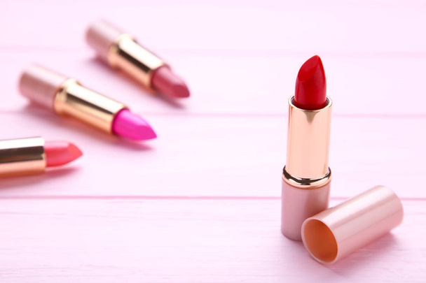 Many lipsticks on pink background. Cosmetic - Valokuva, kuva