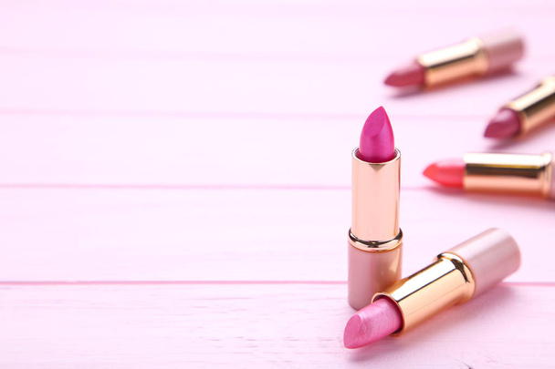Many pink lipsticks on pink background. Cosmetic - Foto, immagini