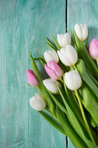 pink and white tulips on turquoise wooden surface - Valokuva, kuva