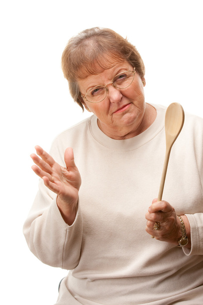 Femme âgée bouleversée avec une cuillère en bois isolée
 - Photo, image