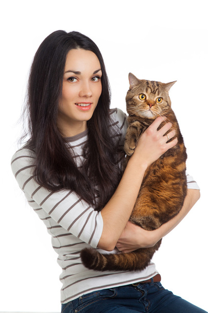beautiful smiling brunette girl and her ginger cat over white ba - Фото, изображение