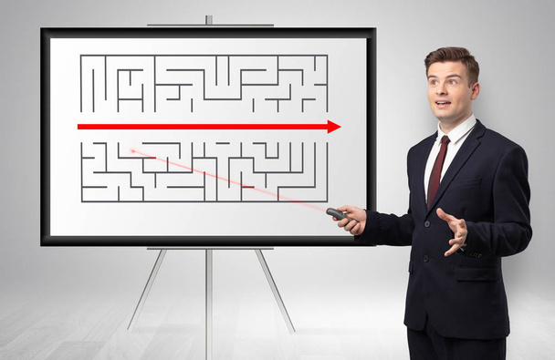 Businessman presenting potential exit from a labyrinth - 写真・画像