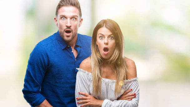 Young couple in love over isolated background afraid and shocked with surprise expression, fear and excited face. - Photo, Image