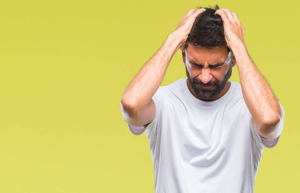 Adult hispanic man over isolated background suffering from headache desperate and stressed because pain and migraine. Hands on head. - Photo, image