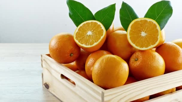 stapel van verse sinaasappelen in houten kist - Video