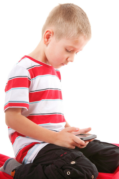 Child plays games on the mobile phone - 写真・画像