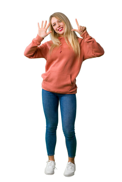 Повнометражний знімок молодої дівчини, що рахує сім з пальцями на ізольованому білому тлі
 - Фото, зображення