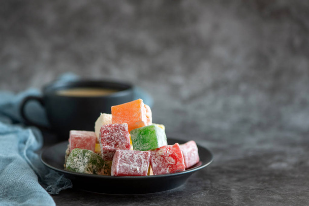 Turkish delight and cup of coffee on grey background. - Photo, Image