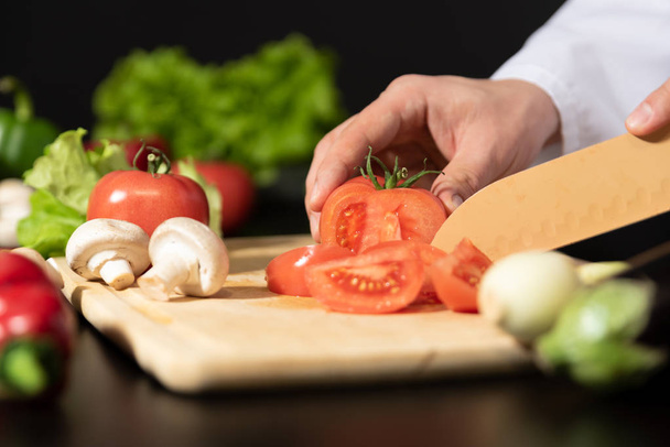 Chef prepares fresh vegetables. Cooking, healthy nutrition concept - Photo, Image