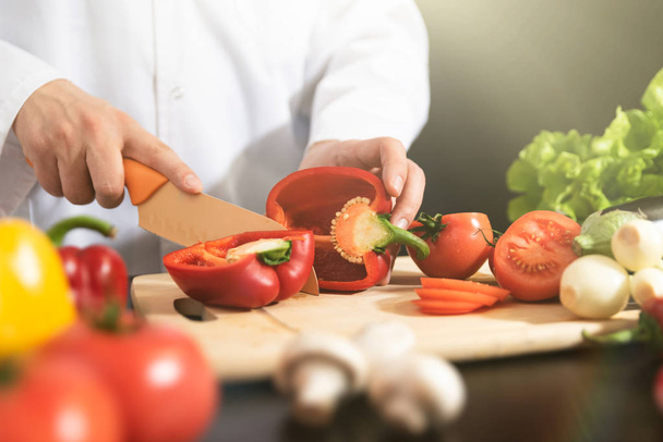 Chef prepares fresh vegetables. Cooking, healthy nutrition concept - Fotografie, Obrázek