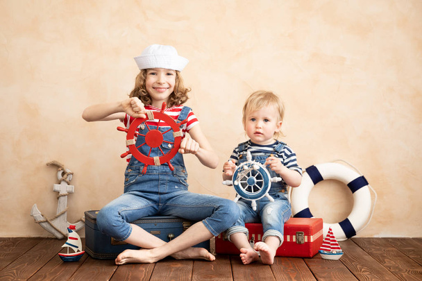 Happy children pretend to be sailor. Funny kids playing at home. Summer vacation and travel concept - Foto, immagini