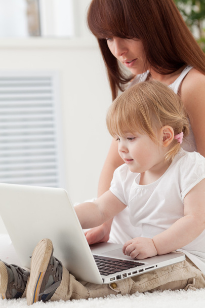 Loving family looking at a laptop - Photo, Image