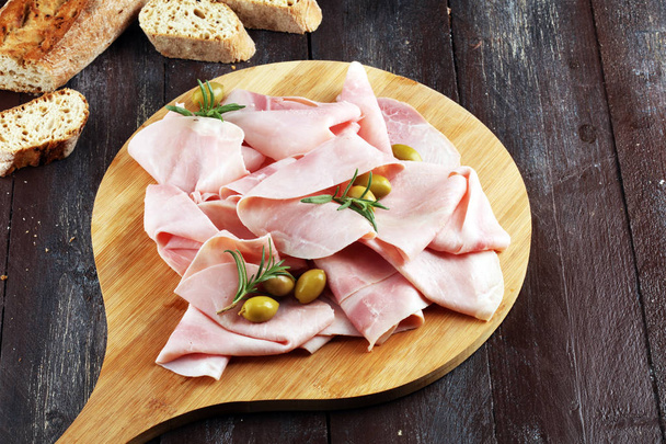 Sliced ham on wooden background. Fresh prosciutto. Pork ham sliced. - Photo, Image