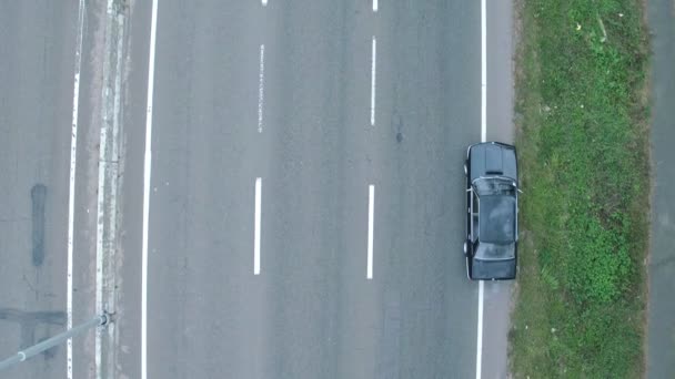 Aerial shooting of car, whichis on the autobahn. Aerial view of retro black bmw, whichis on the autobahn - Footage, Video