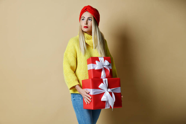 Beautiful woman hold red birthday or valentines day presents gift boxes for new year celebration smiling - Fotoğraf, Görsel