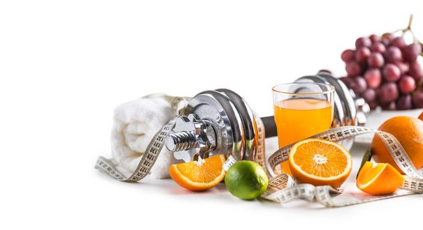Sport dumbbells fresh fruit measure tape and multivitamin juice isolated on white background. Healthy sport and diet concept. - Фото, изображение