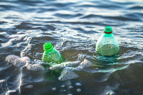 Plastic bottle in the sea. Discharge of plastic waste into the sea. Environmental and water pollution - Foto, immagini