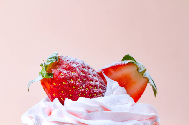Tasty strawberry cake with whipped cream on a pink background. Pastry. Sweet dessert - 写真・画像