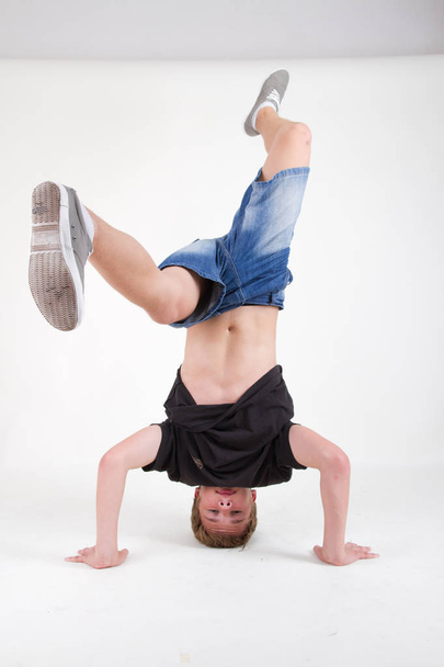 Teenager bboy training on white background  - Фото, изображение