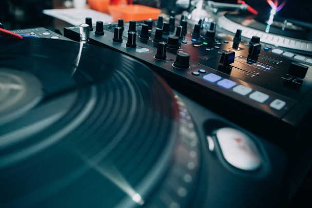 Turntable dj vinyl record player and sound mixing controller.Analog and digital sound technology for DJ to play music.Close up, macro of disc jockey equipment for professional studio,concert,event set - 写真・画像