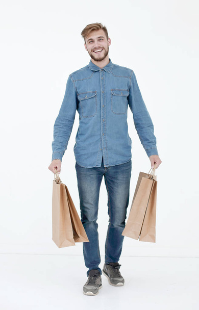 a young guy with brown paper bags in his hands. - Foto, imagen